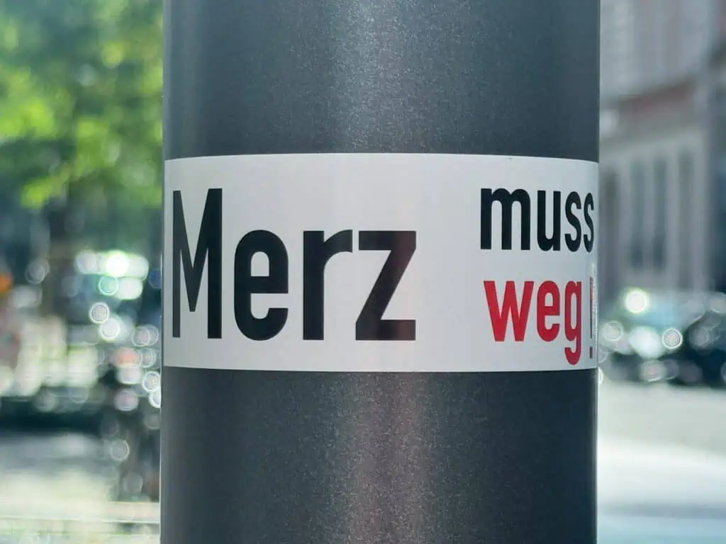 A pole with a sticker on it that says merz